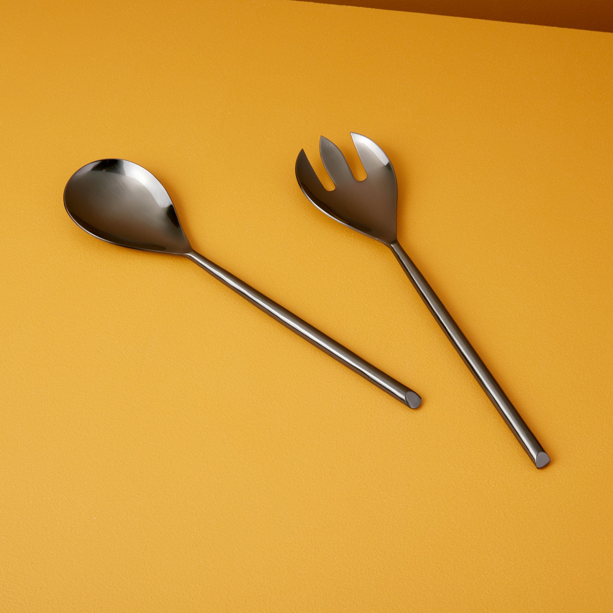 Orange plastic spoon-shaped salad tosser from a picnic set