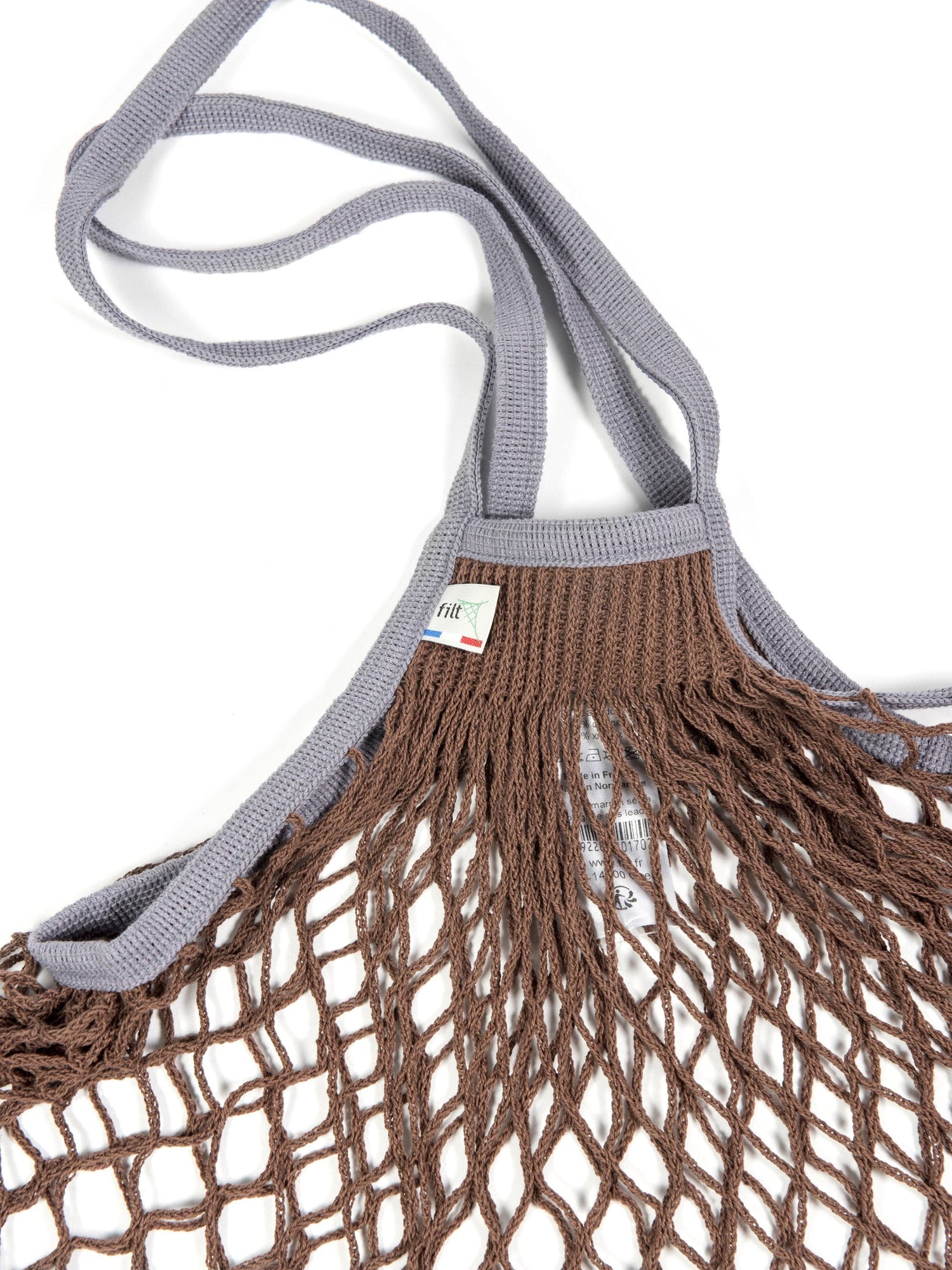 Brown netted tote with grey handles with tag reading Filt.