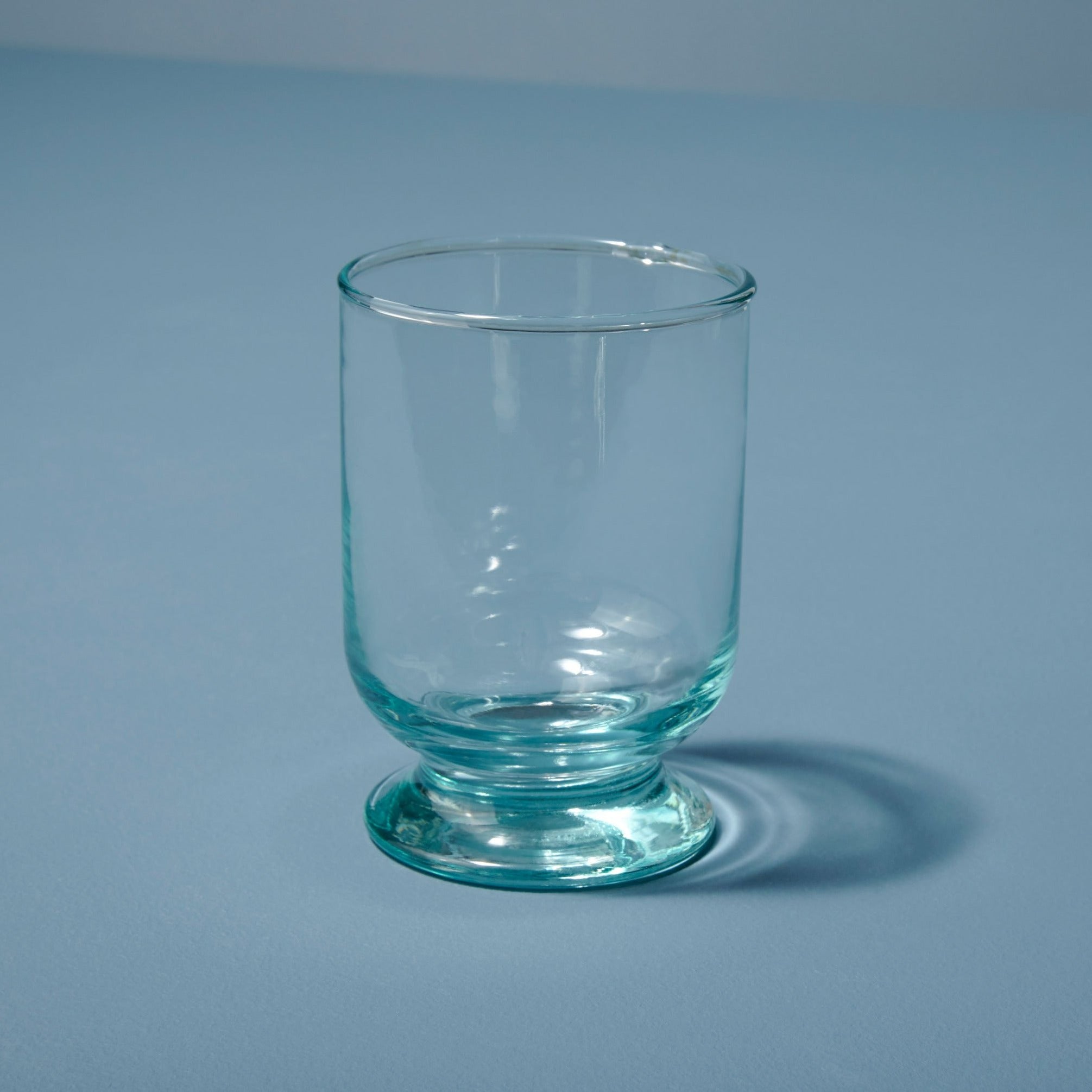 https://behome.com/cdn/shop/products/Be-Home_Recycled-Glass-Footed-Tumbler_46-21_2.jpg?v=1675213032&width=3840